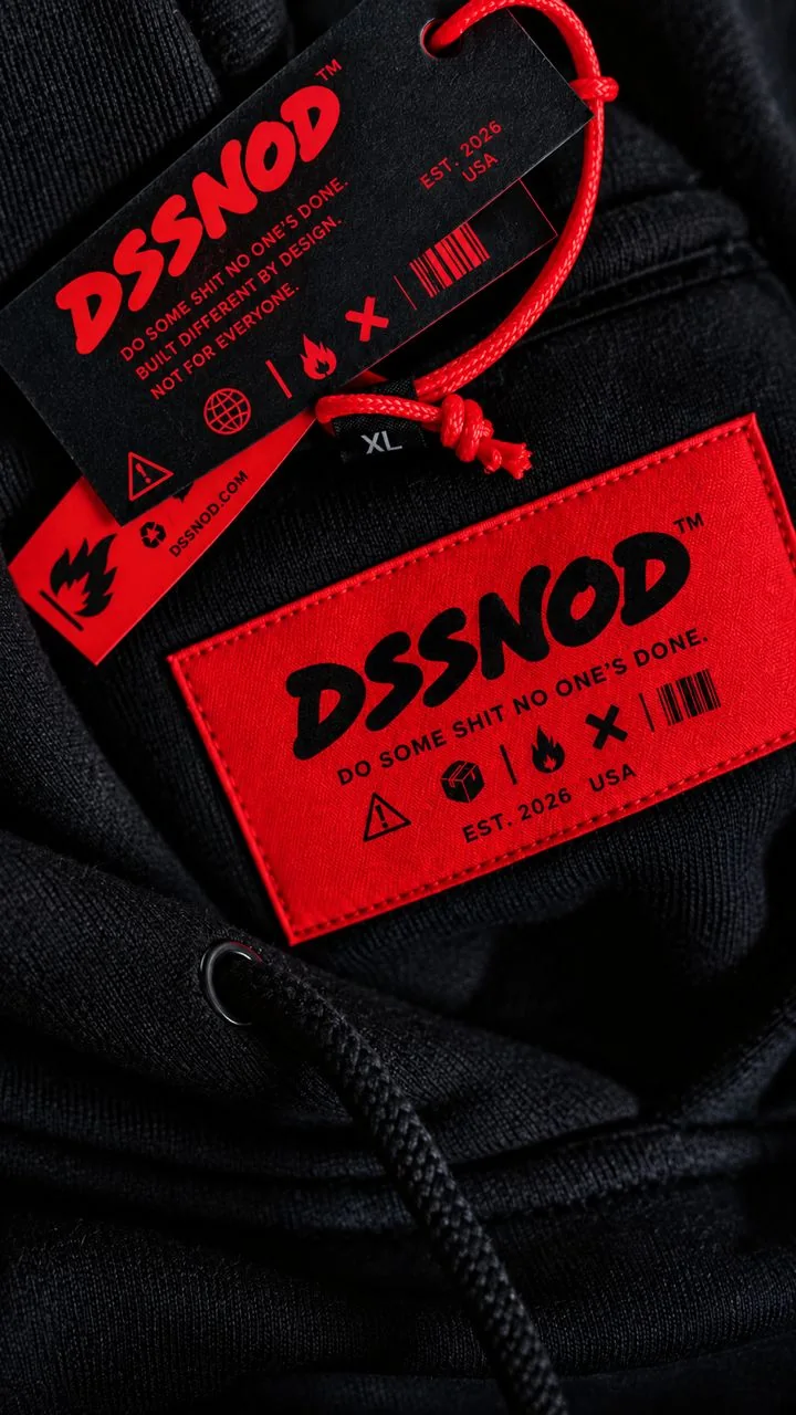 A black hoodie with a red woven DSSNOD label and a black hang tag on a red cord
