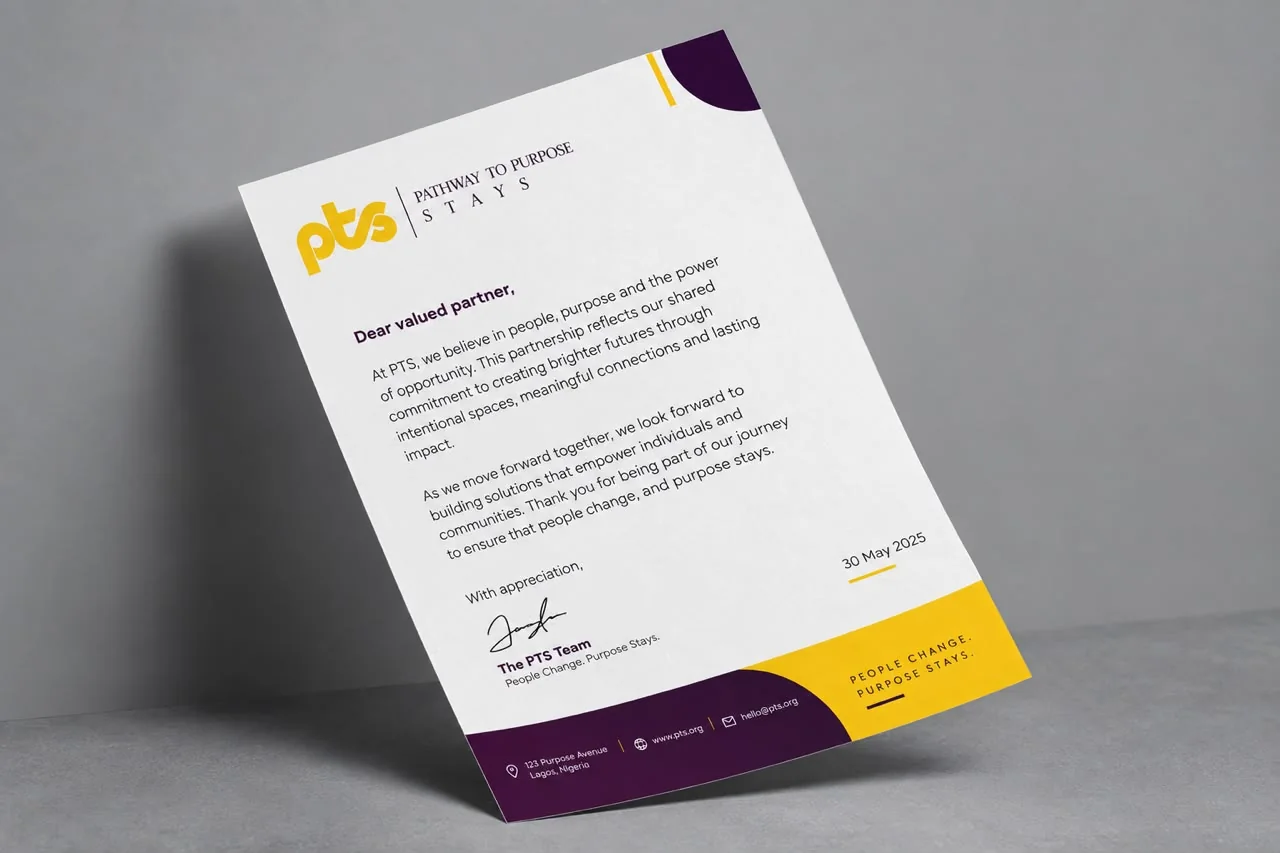 A PTS letterhead with the yellow logo and a plum and yellow footer, standing against a grey wall