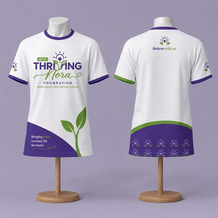 The front and back of a white t-shirt with purple trim and a green leaf print on two mannequins