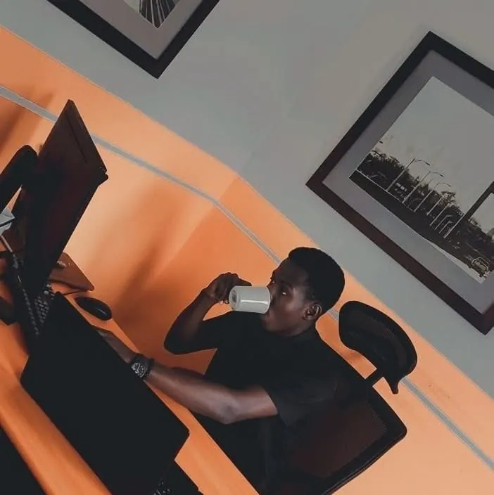A team member working at a desk in a bright orange office